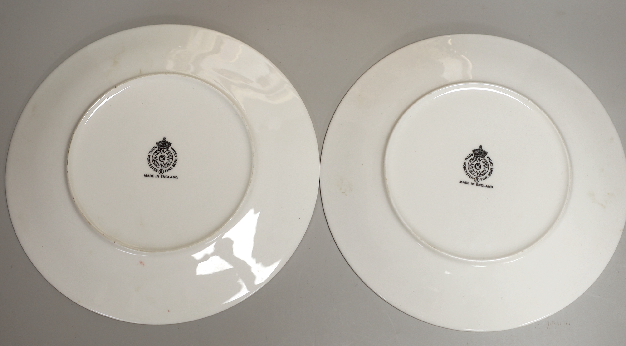 A Royal Worcester fine plate painted with a figure in a tree line landscape by G. Evans, signed and Royal Worcester plates by M Tague, signed with a Bullfinch and a Gold Finch